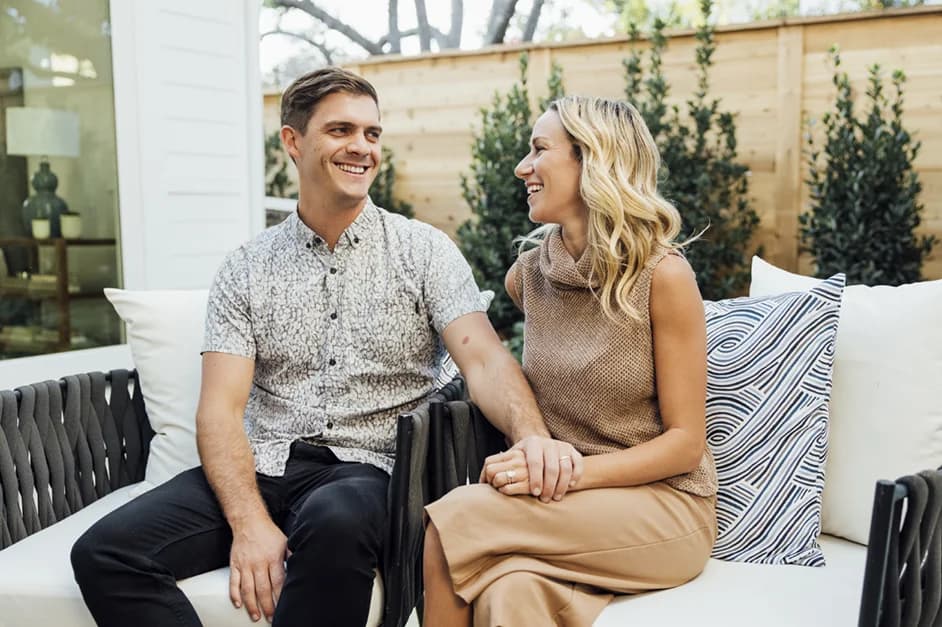 Home owners happily sitting on patio couch